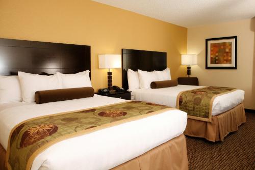a hotel room with two beds and two lamps at Best Western Plus Goldsboro in Goldsboro