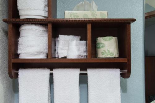a bunch of towels on a shelf in a bathroom at The Hotel at Dayton South in Dayton
