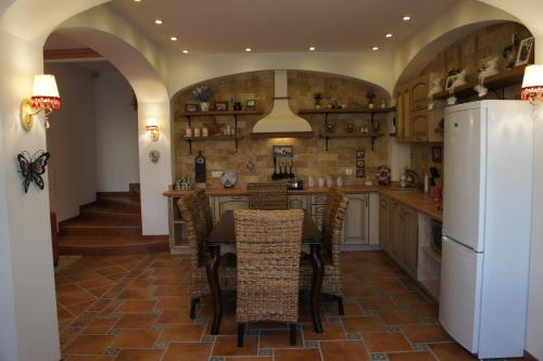 a kitchen with a table and a refrigerator at Bonita in Zatoka