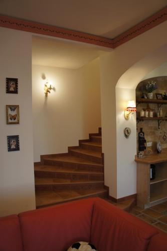 a living room with a red couch and stairs at Bonita in Zatoka