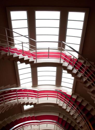 a spiral staircase in a building with windows at The Midland in Morecambe