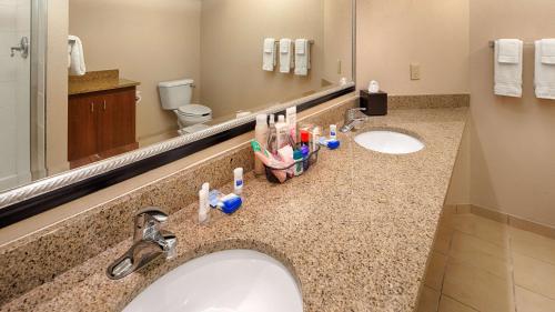 a bathroom with two sinks with toothbrushes at Best Western Benton Harbor – St. Joseph in Benton Harbor