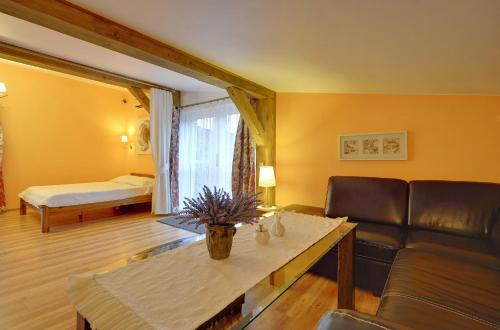 a living room with a couch and a table at Willa pod Czantorią SPA Ustroń in Ustroń