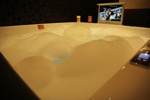 a bath tub with a shadow of a batman on it at Hotel OK in Prizren