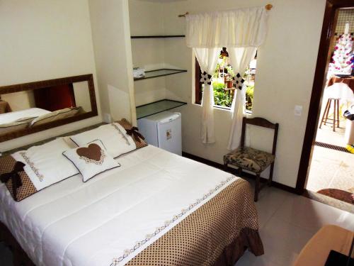 安格拉杜斯雷斯的住宿－Pousada Paraguaya，卧室设有一张白色大床和一扇窗户。