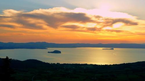 a sunset over a large body of water at Antica residenza La Rocca in Montefiascone