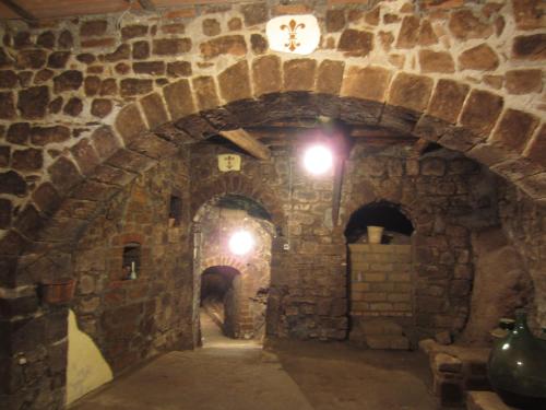 a stone tunnel with a clock on the wall at Antica residenza La Rocca in Montefiascone