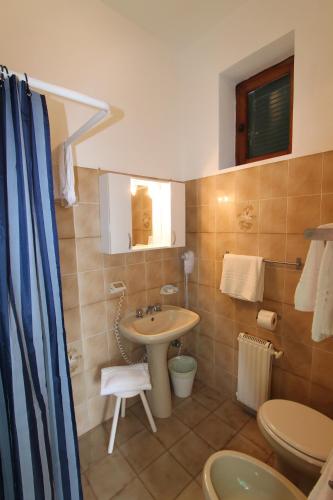 a bathroom with a sink and a toilet at Hotel La Marinella in Castiglioncello