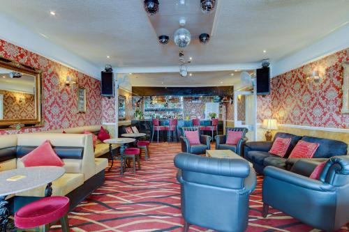 a bar with couches and tables and chairs at New Brooklyn in Blackpool