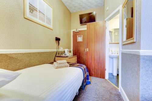 a hotel room with a bed and a bathroom at New Brooklyn in Blackpool