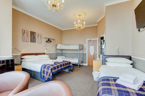 a hospital room with two beds and a chandelier at New Brooklyn in Blackpool