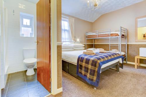 a bedroom with a bunk bed and a toilet at New Brooklyn in Blackpool