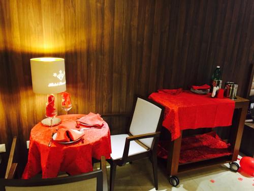 a table and chairs with a red table cloth on it at Hotel Smeraldo in Qualiano