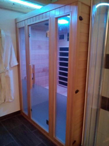 a shower with glass doors in a bathroom at Pri štorklji in Moravske Toplice