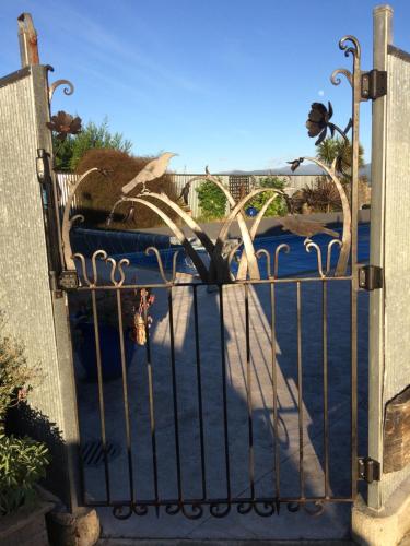 a gate to a driveway with a fence at Languor B&B in Carterton