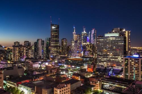a city at night with many tall buildings at Citadines on Bourke Melbourne in Melbourne