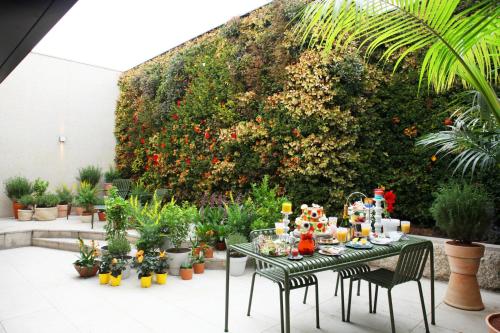 a table with food on it in a garden at Maison Glad Jeju in Jeju
