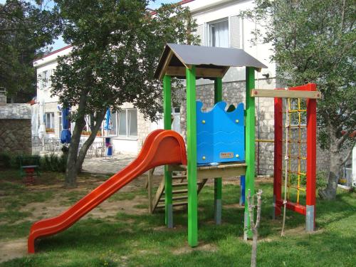 a playground with a slide in a yard at Vila Punta in Šibuljina