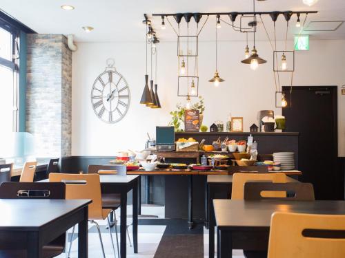 a restaurant dining room with tables and chairs at Hotel AreaOne Nobeoka in Nobeoka