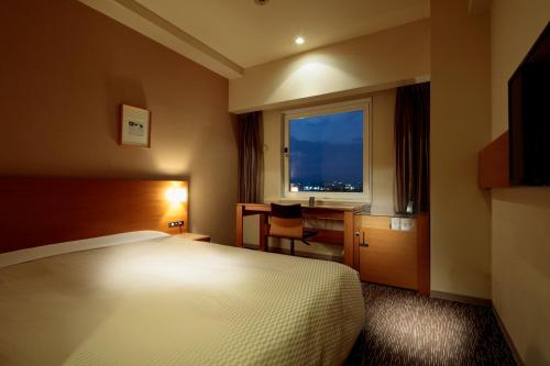 Postel nebo postele na pokoji v ubytování Candeo Hotels Sano