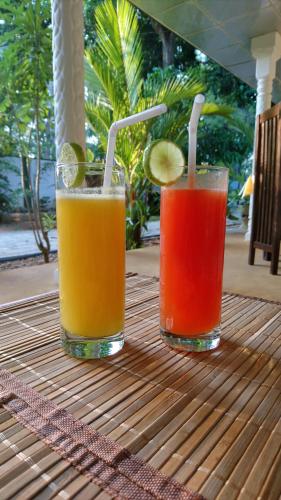 two cocktails sitting on top of a table at Yala Southern Homestay in Tissamaharama