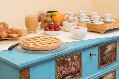 a table with a pie and other foods on it at Fattoria Pian Di Rocca in Castiglione della Pescaia