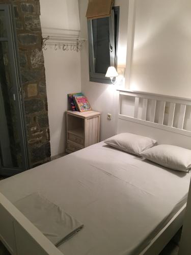 a bedroom with a large white bed with a mirror at Summer dream , 5 min walk to the beach in Livadakia