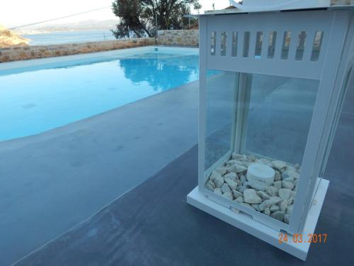 a small fish tank next to a swimming pool at Galini Breeze in Agia Galini