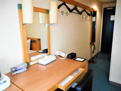 เตียงในห้องที่ Kuretake Inn Asahikawa