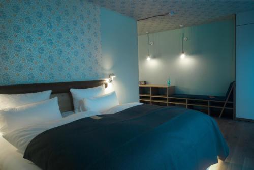 a bedroom with a bed with a blue at Hotel Gude in Kassel