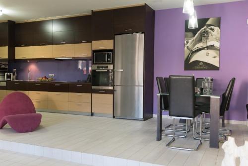 a kitchen with a refrigerator and a table and chairs at Thomis Beach House in Kato Daratso