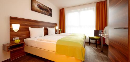 a hotel room with a bed and a window at ante porta DAS STADTHOTEL in Trier