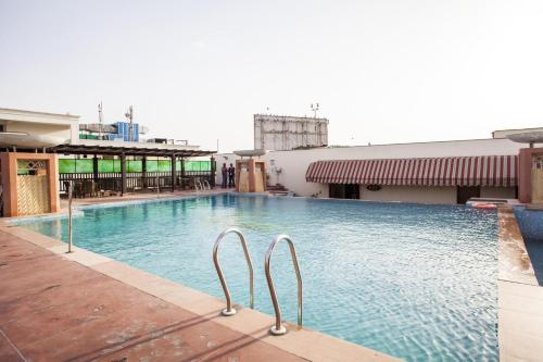 a swimming pool on top of a building at Clarion Bella Casa at Airport in Jaipur