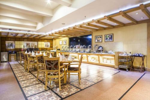 a restaurant with a table and chairs and a bar at Clarion Bella Casa at Airport in Jaipur