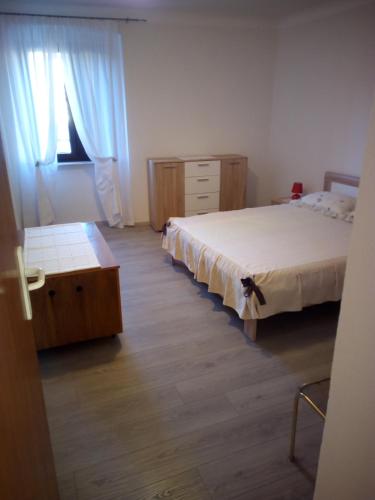 a bedroom with two beds and a dresser at Apartment Nonna Maria in Umag