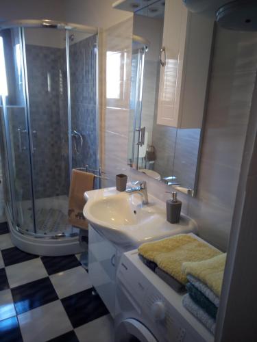 a bathroom with a sink and a shower and a toilet at Apartment Nonna Maria in Umag