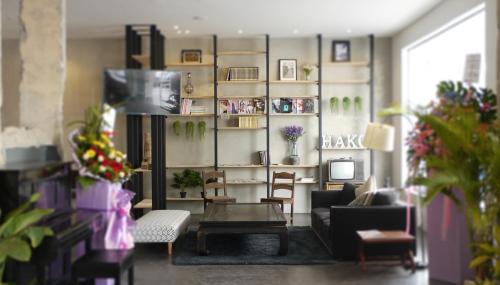 a living room with a couch and a table at Hako Hotel in Skudai