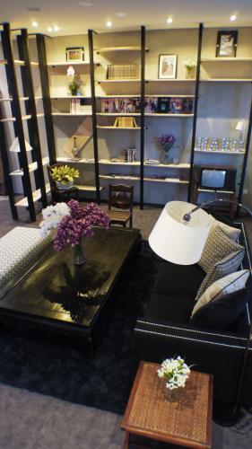 a living room with a couch and a table with flowers at Hako Hotel in Skudai