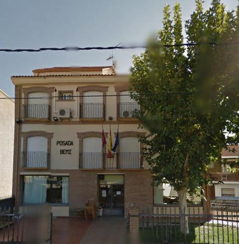 a building with two flags in front of it at Bar Posada Bemi in Almorox