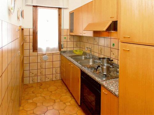 A kitchen or kitchenette at Lignano Riviera with fireplace & air conditioning