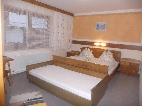 a small bedroom with two beds and a window at Haus Rohregger in Mittersill