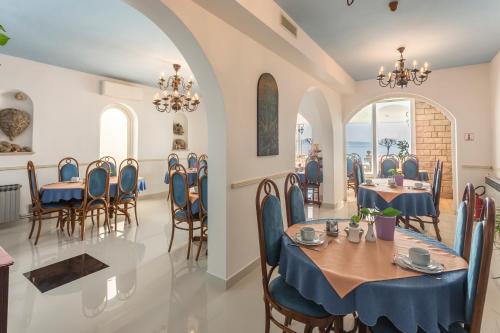 a dining room with tables and chairs and the ocean at Villa Amigo in Podstrana