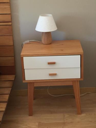 a bedside table with a lamp and a drawer at Apartamento Smart in Buenos Aires