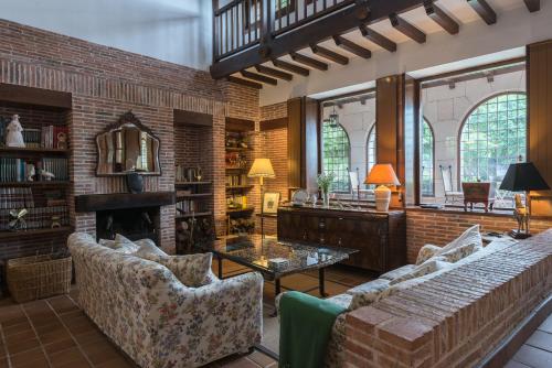 a living room with two couches and a fireplace at Molino De La Vega in Arcos