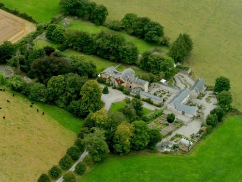 an aerial view of a large house with trees at Kilgraney House in Bagenalstown