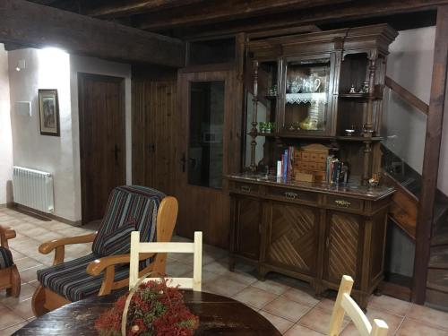 a living room with a cabinet and a table at El Pajar del Castillo in Mora de Rubielos