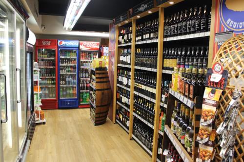 a store aisle with a lot of bottles of wine at Apartamentos Turisticos Paraiso in Funchal