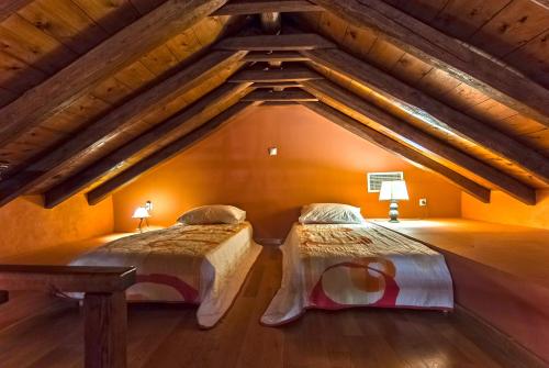 two beds in a room with an attic at Petropoulakis Tower in Gythio