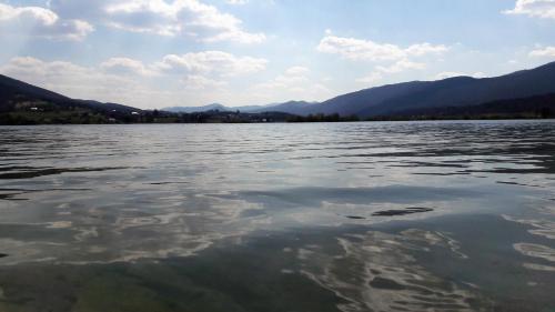 a large body of water with mountains in the background at Spacious Apartment "Ana" on lake Sabljaci in Ogulin