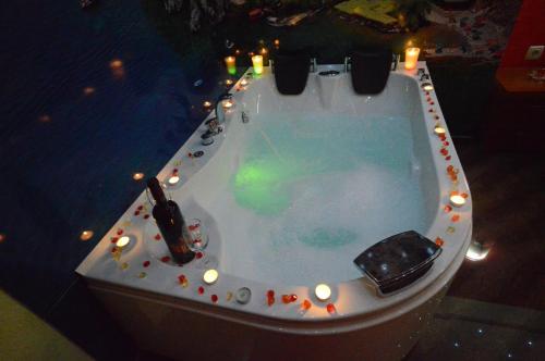 a jacuzzi tub with candles and lights in it at Villa Maki in Ohrid